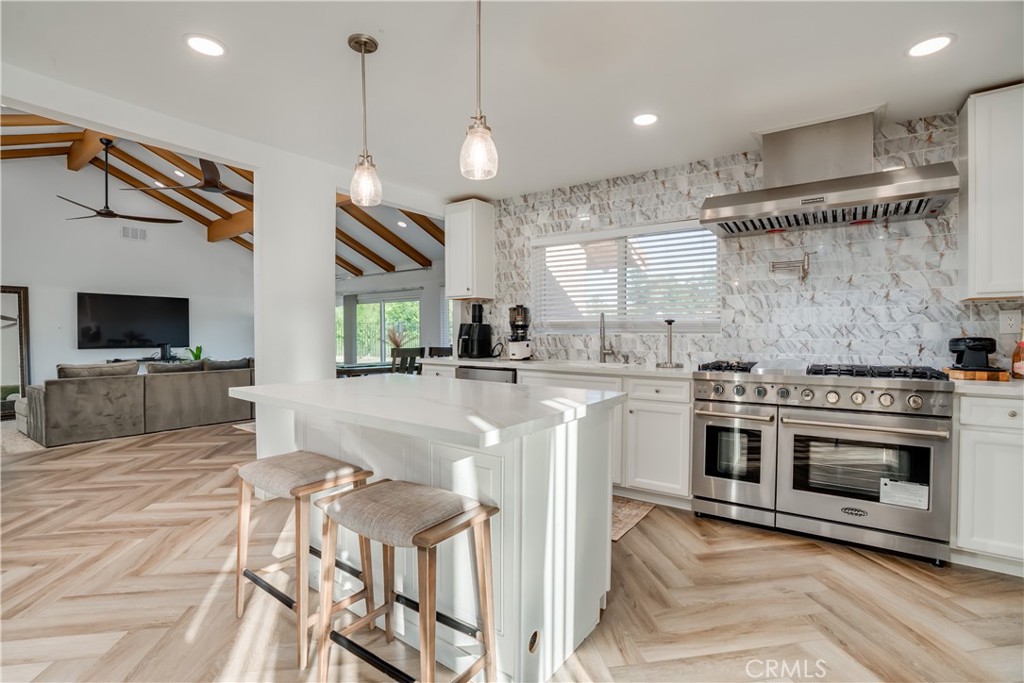 1450 Vía Vallarta Riverside, CA 92506 - Photo 17 of 36 a kitchen with stainless steel appliances granite countertop a sink a stove and a refrigerator