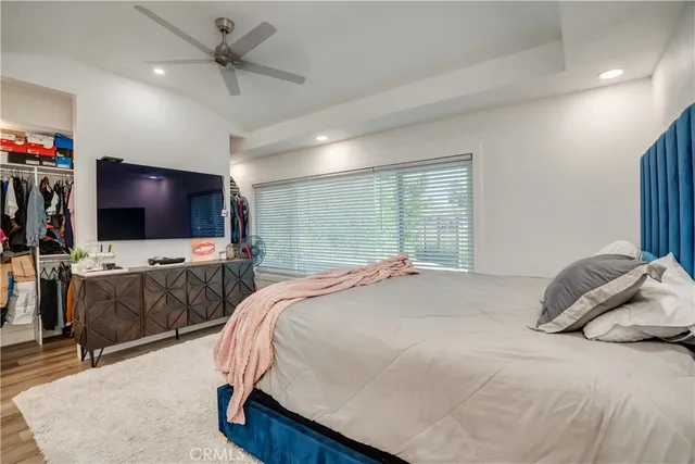 a bedroom with a bed and a flat screen tv