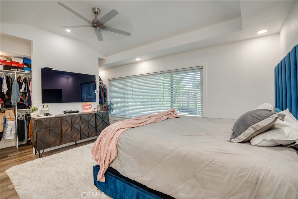 1450 Vía Vallarta Riverside, CA 92506 - Photo 23 of 36 a bedroom with a bed and a flat screen tv