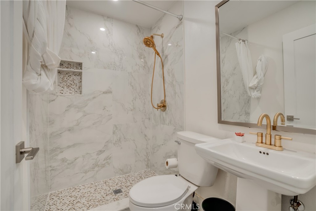 1450 Vía Vallarta Riverside, CA 92506 - Photo 26 of 36 a bathroom with a sink toilet and shower