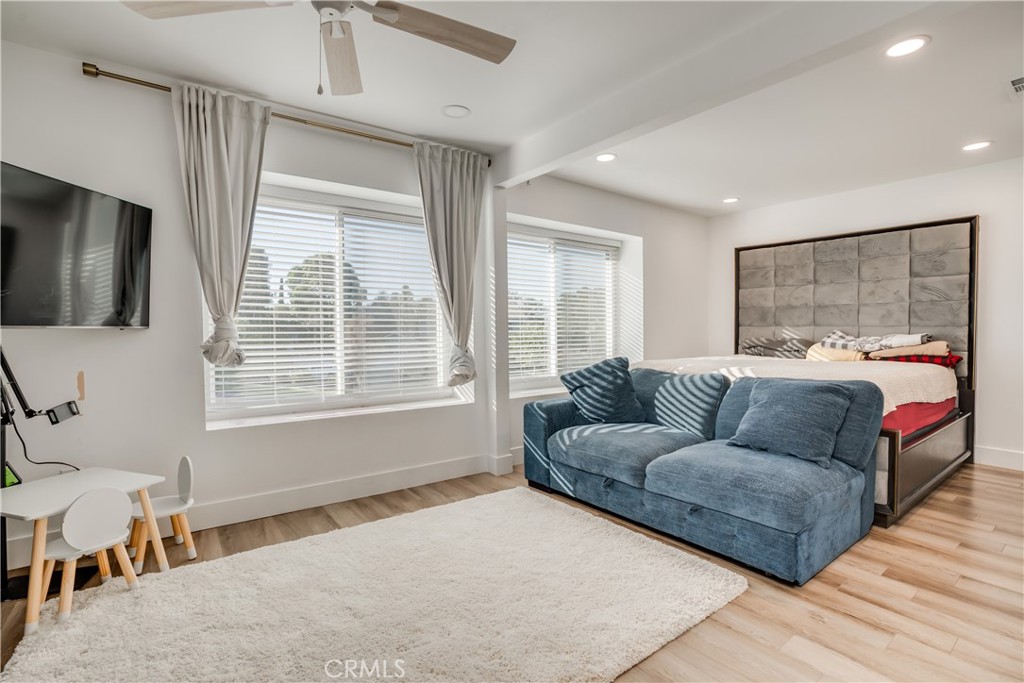 1450 Vía Vallarta Riverside, CA 92506 - Photo 27 of 36 a bedroom with a bed couch and window