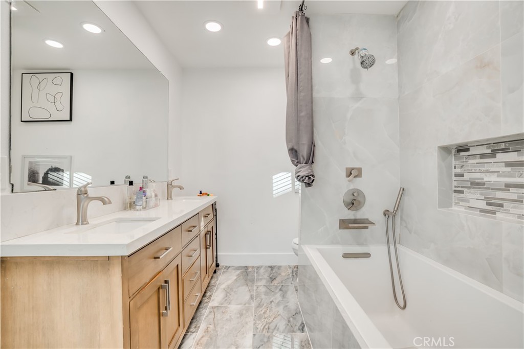1450 Vía Vallarta Riverside, CA 92506 - Photo 30 of 36 a bathroom with a tub sink and mirror