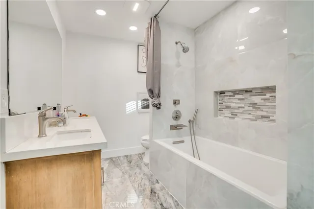 a bathroom with a bathtub and a sink