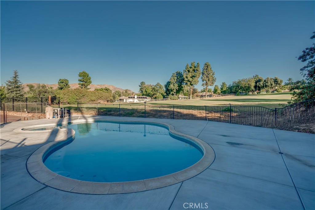 1450 Vía Vallarta Riverside, CA 92506 - Photo 33 of 36 a view of a swimming pool with an outdoor seating