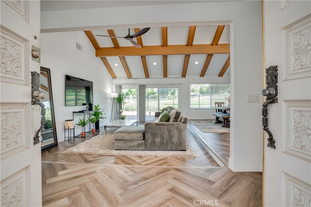 1450 Vía Vallarta Riverside, CA 92506 - Photo 7 of 36 a large white room with a large window and furniture