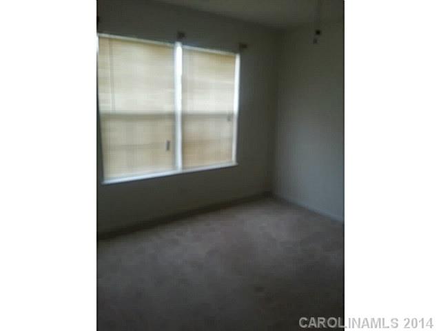 911 Reigate Road Charlotte, NC 28262 - Photo 9 of 14 a view of an empty room with a window