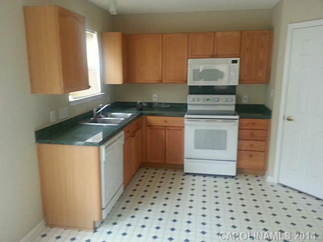 911 Reigate Road Charlotte, NC 28262 - Photo 10 of 14 a kitchen with a stove a sink and a refrigerator