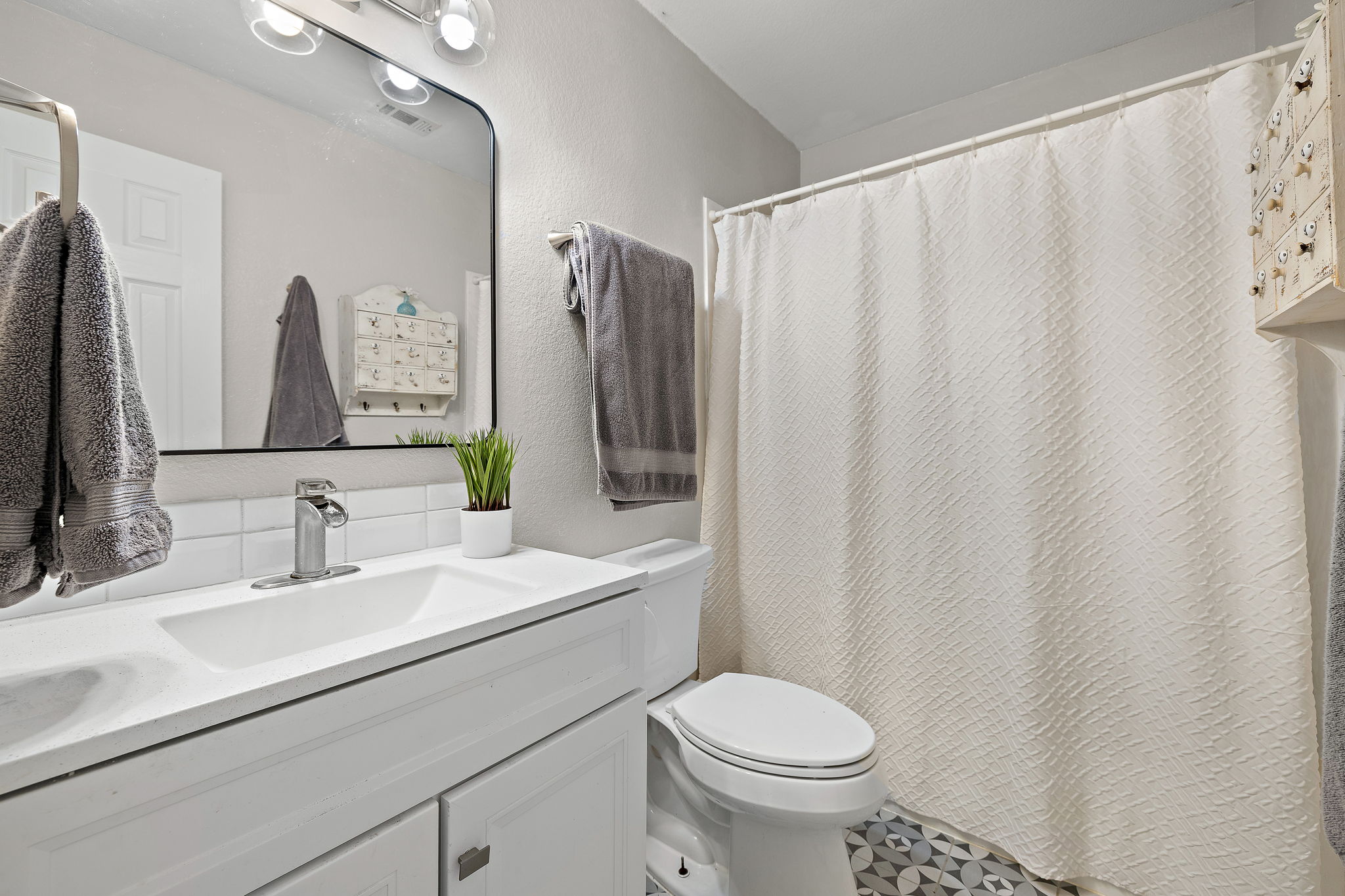 107 Easy Street Hutto, TX 78634 - Photo 16 of 34 a bathroom with a sink a toilet and a mirror
