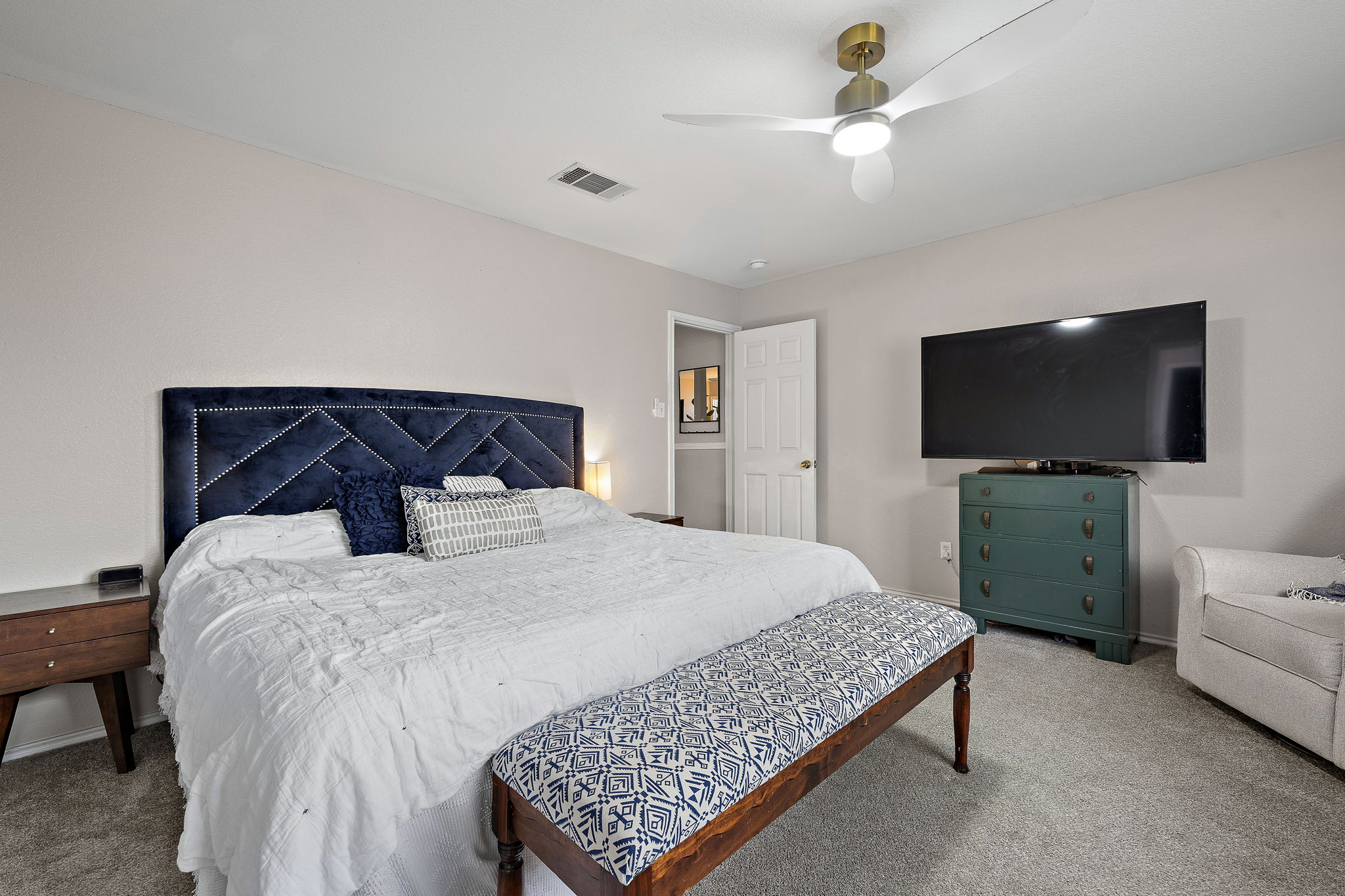 107 Easy Street Hutto, TX 78634 - Photo 17 of 34 a bedroom with a bed and a flat screen tv