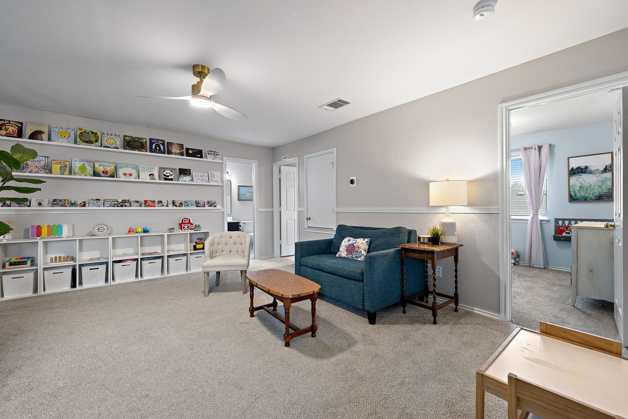 107 Easy Street Hutto, TX 78634 - Photo 21 of 34 a bedroom with furniture and a book shelf