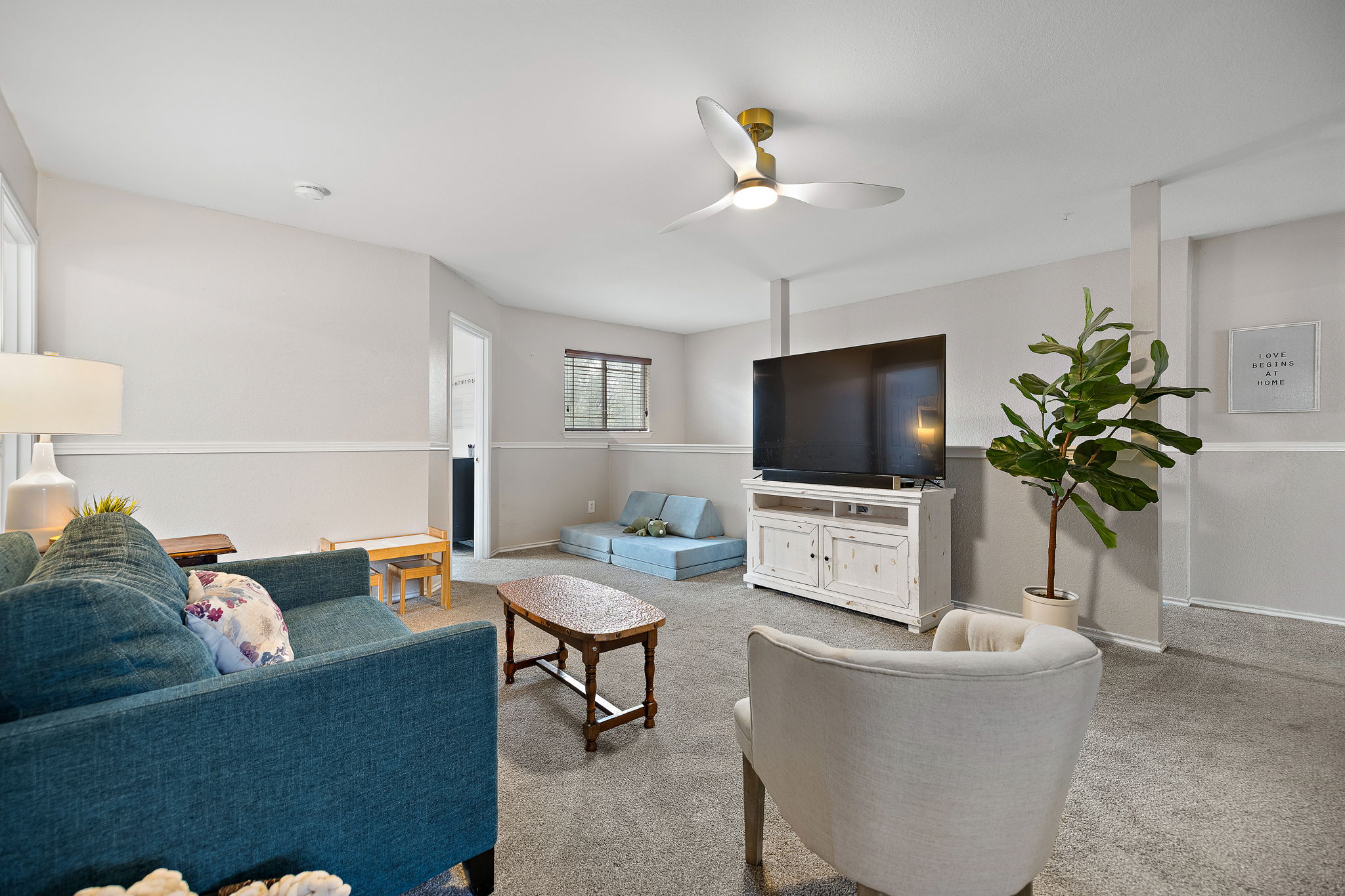107 Easy Street Hutto, TX 78634 - Photo 23 of 34 a living room with furniture and a flat screen tv