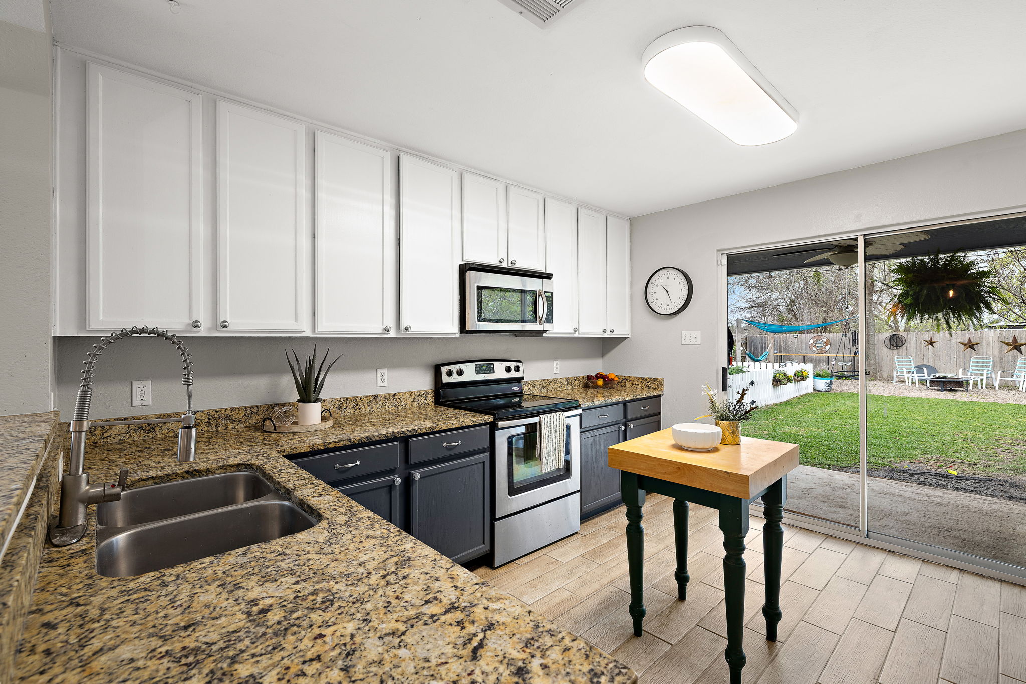107 Easy Street Hutto, TX 78634 - Photo 6 of 34 a kitchen that has a sink and a stove in it