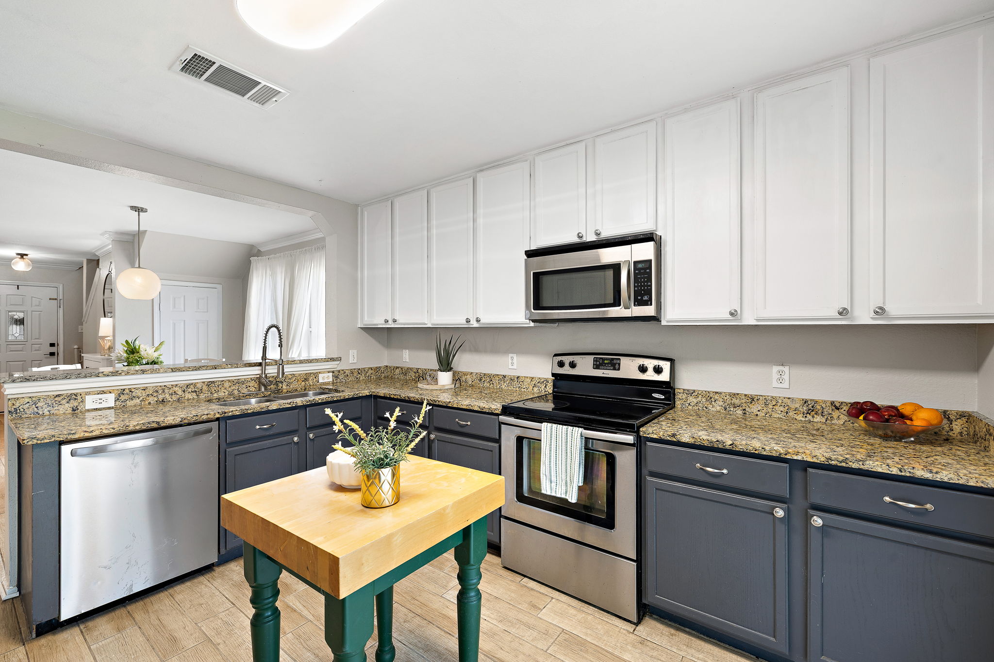 107 Easy Street Hutto, TX 78634 - Photo 7 of 34 a kitchen with stainless steel appliances granite countertop a stove top oven a sink dishwasher and cabinets with wooden floor