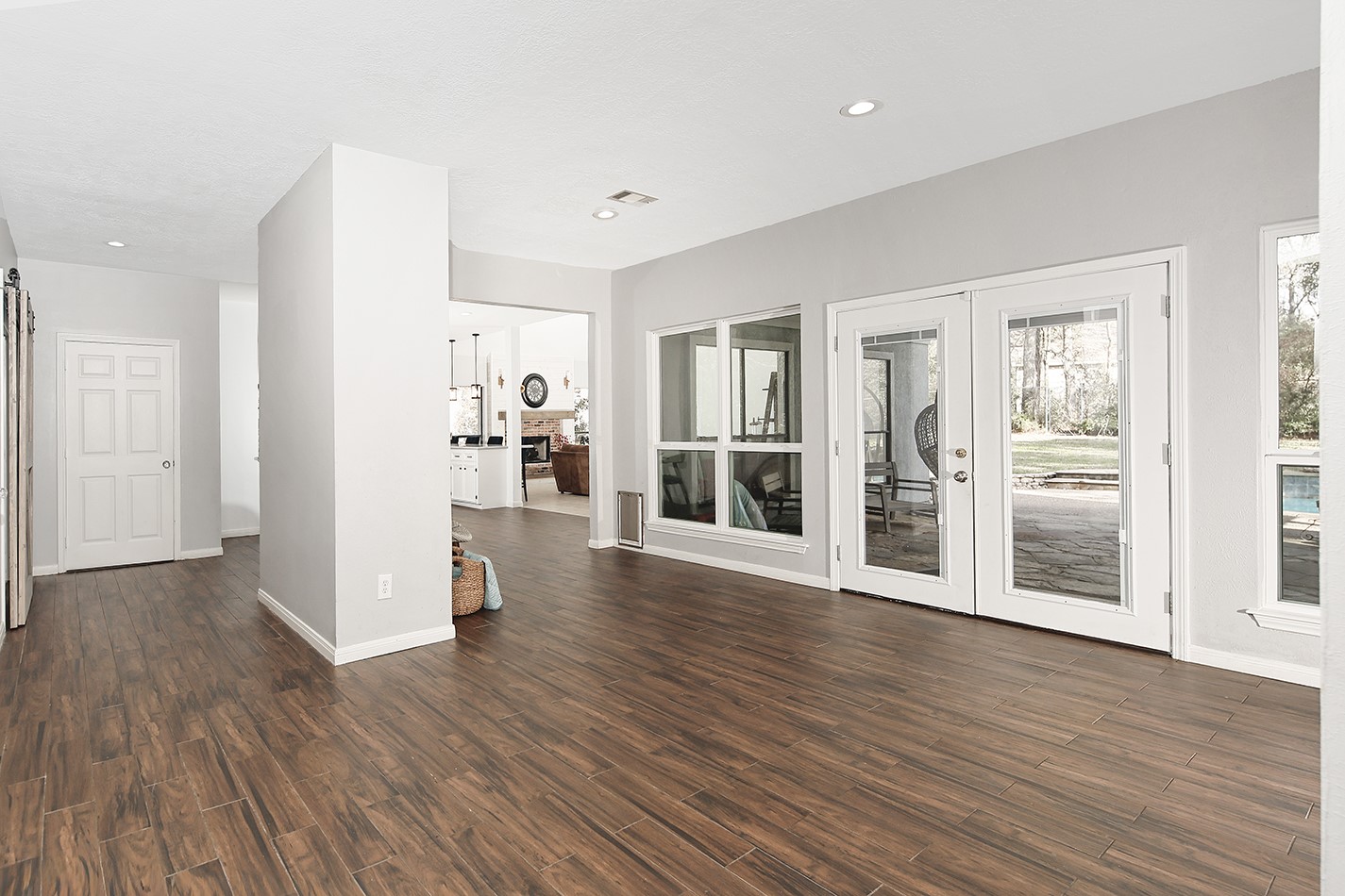 44 Lake Forest Circle Conroe, TX 77384 - Photo 4 of 45 wooden floor in an empty room with a window