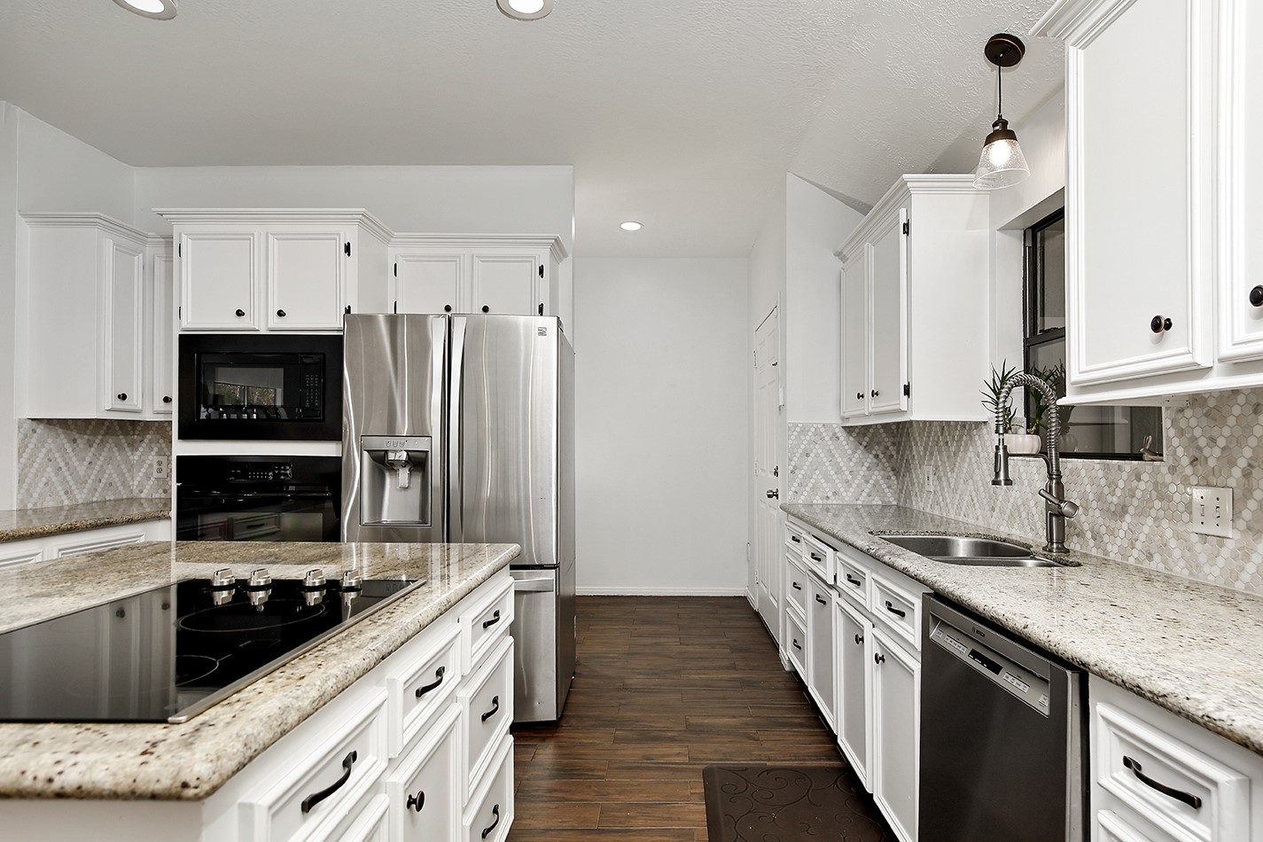 44 Lake Forest Circle Conroe, TX 77384 - Photo 8 of 45 a kitchen with stainless steel appliances kitchen island granite countertop a sink stove and refrigerator