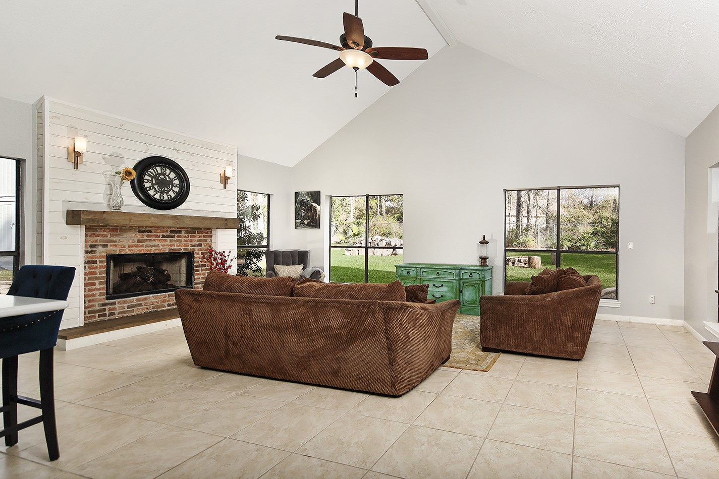 44 Lake Forest Circle Conroe, TX 77384 - Photo 10 of 45 a living room with furniture a fireplace and a large window
