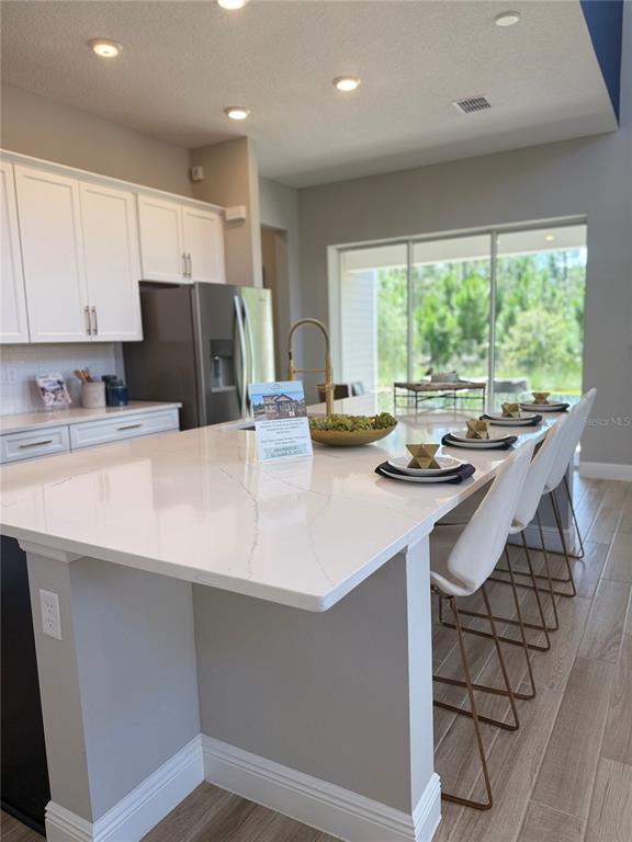 2948 Scout Street St. Cloud, FL 34771 - Photo 28 of 91 a kitchen with a sink a stove and chairs