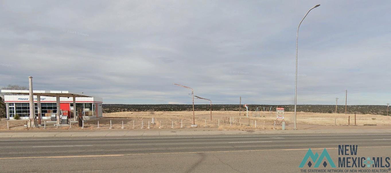 2391 U.S. Route 66 Santa Rosa, NM 88435 - Photo 2 of 6 View of asphalt street featuring street lights, sidewalks, and curbs