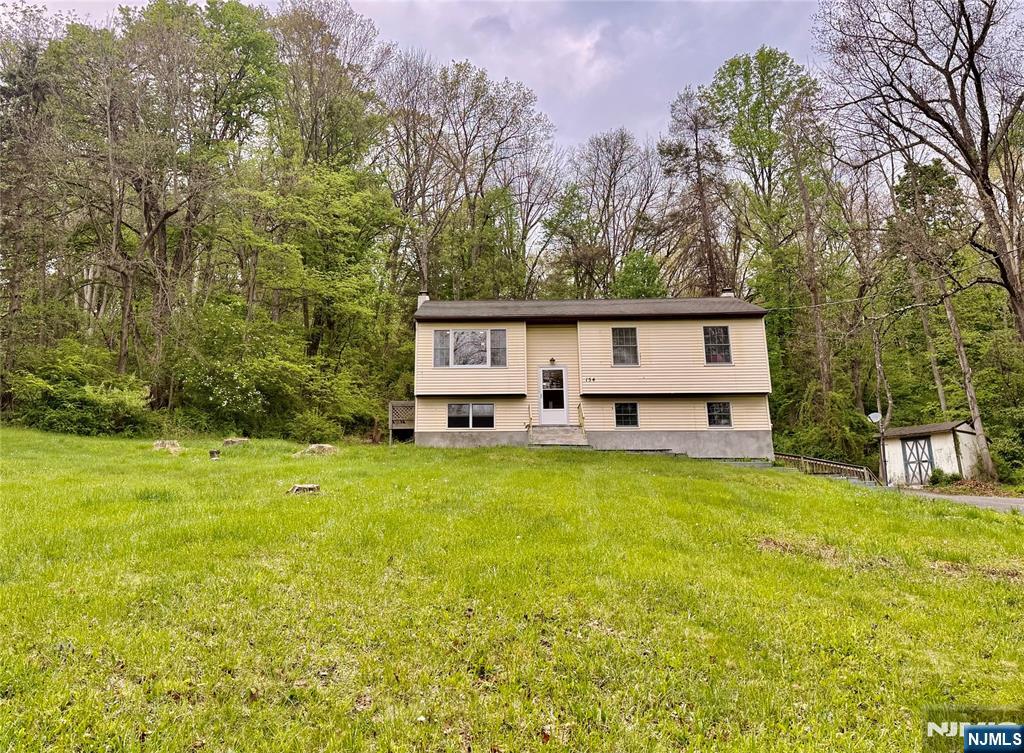 154 Cork Hill Road Franklin, NJ 07416 - Photo 27 of 35 a view of a house with a yard and sitting area
