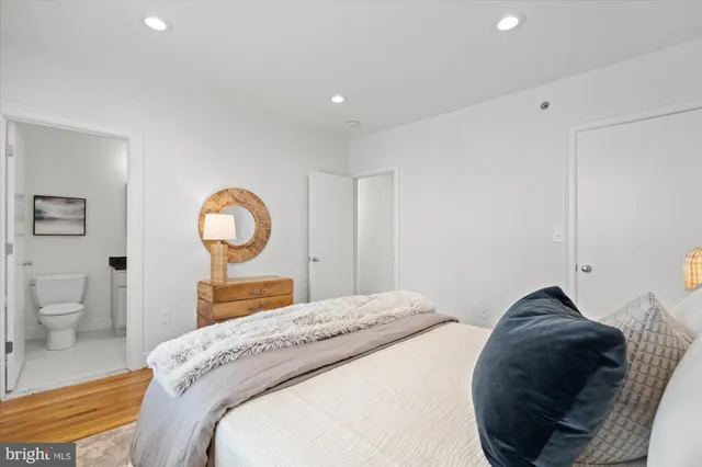 a bedroom with a bed and mirror