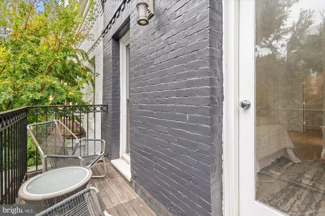 a balcony with table and chairs