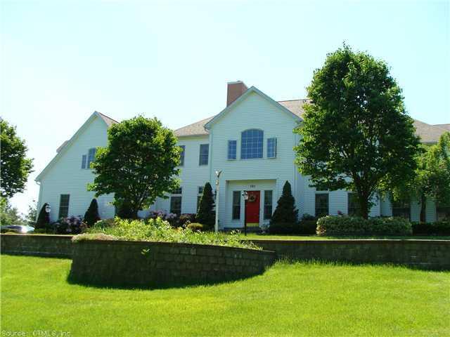 a front view of a house with a garden and yard
