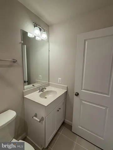 a bathroom with a sink toilet and mirror