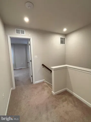 an empty room with a empty space and windows