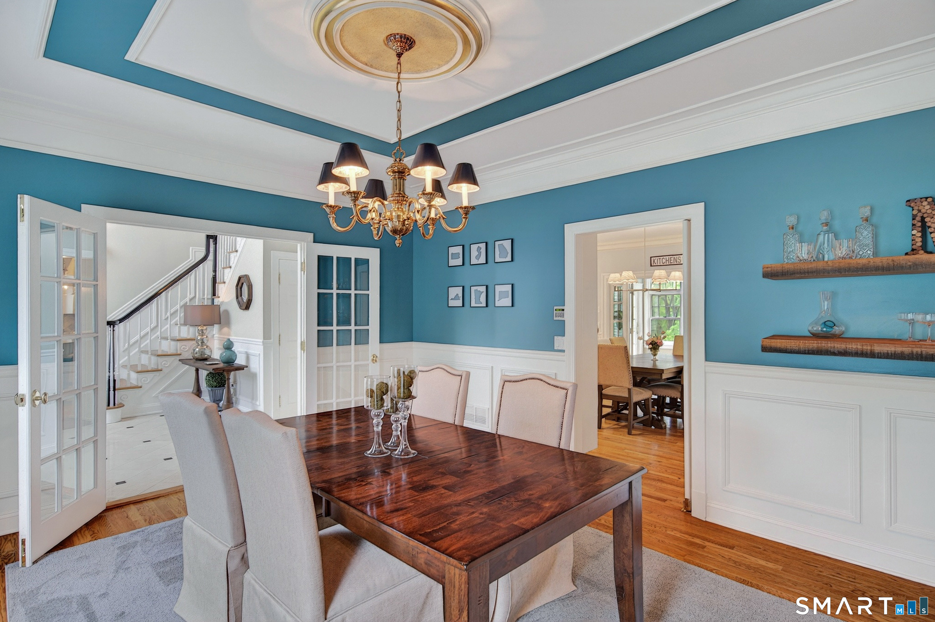16 Farm Meadow Road Newtown, CT 06470 - Photo 3 of 40 a dining room with wooden floor a chandelier a wooden table and chairs