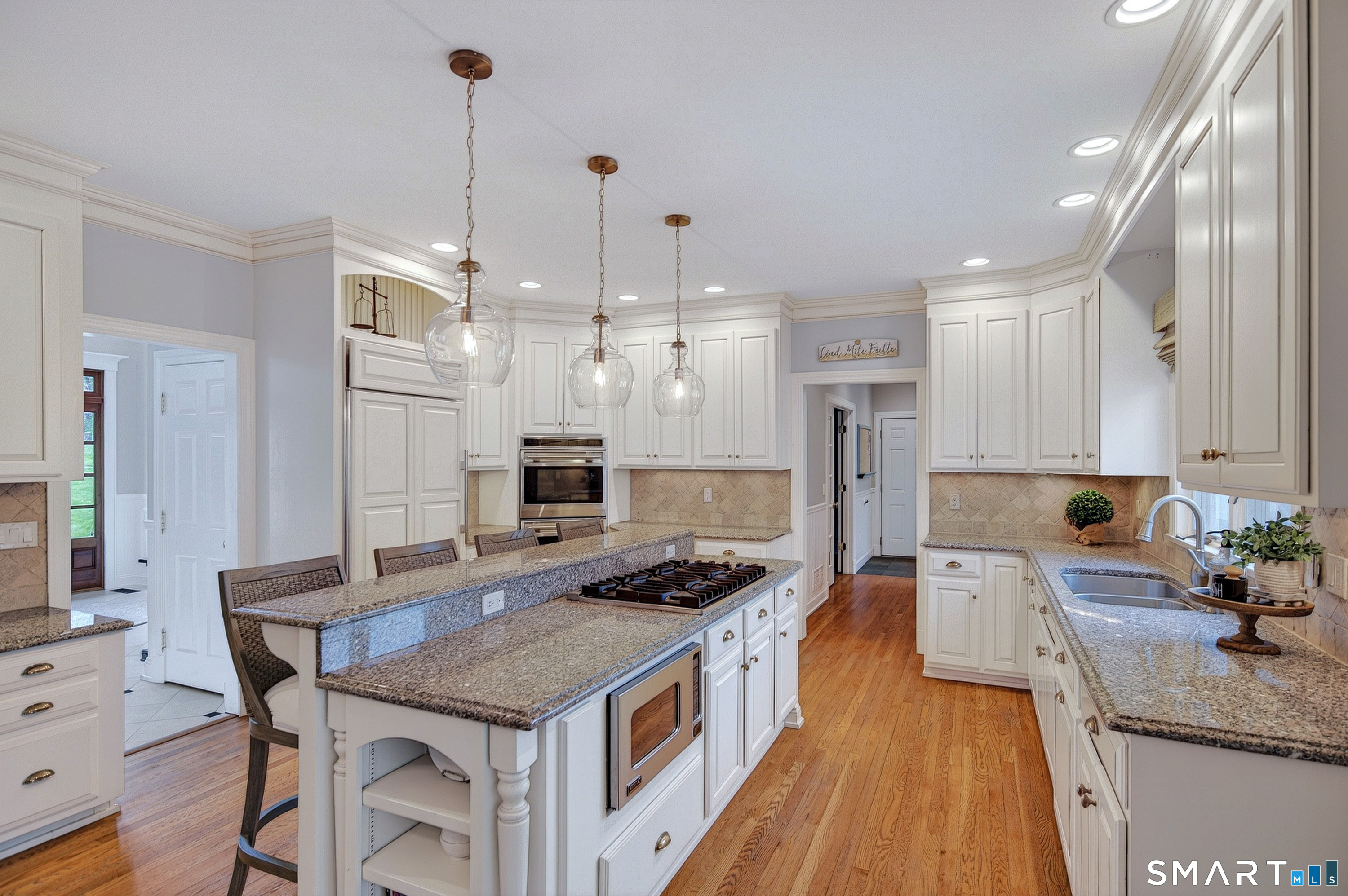 16 Farm Meadow Road Newtown, CT 06470 - Photo 5 of 40 a kitchen with stainless steel appliances granite countertop a stove a sink dishwasher a refrigerator white cabinets and wooden floor