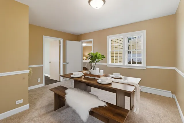 a dining room with furniture and wooden floor