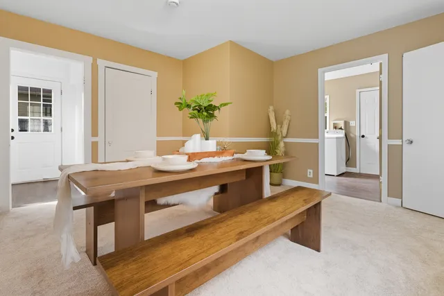a room with a table chairs and wooden floor