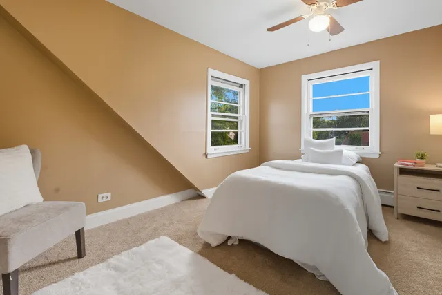 a bedroom with a bed and window