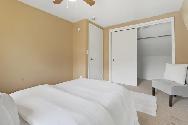 a bedroom with a bed and a chair