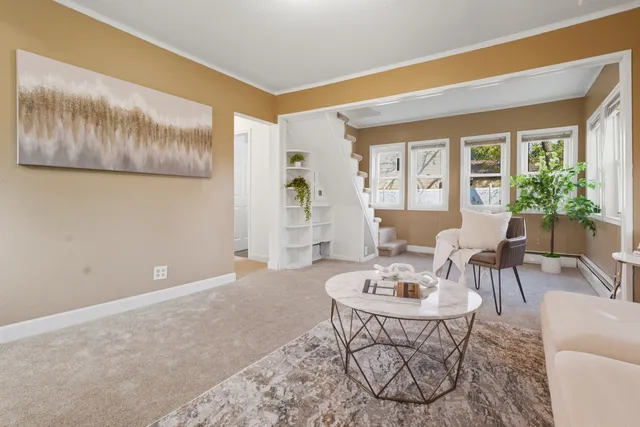 a living room with furniture and a large window