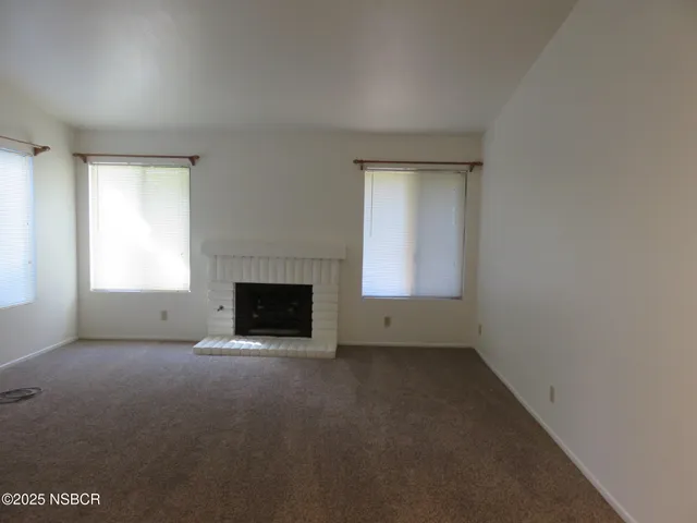 an empty room with a fireplace