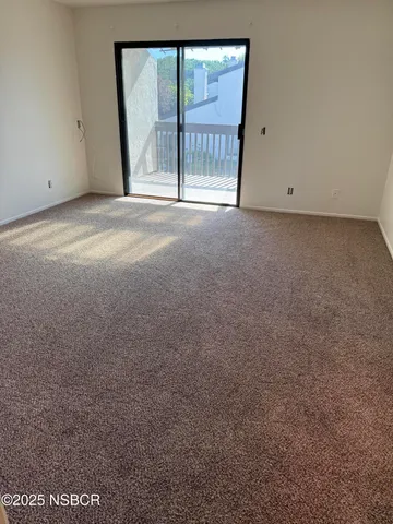 a view of an empty room with a balcony
