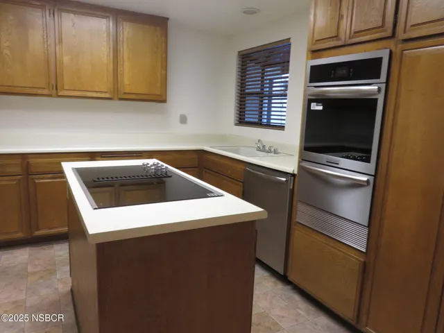 a kitchen with a sink appliances and cabinets