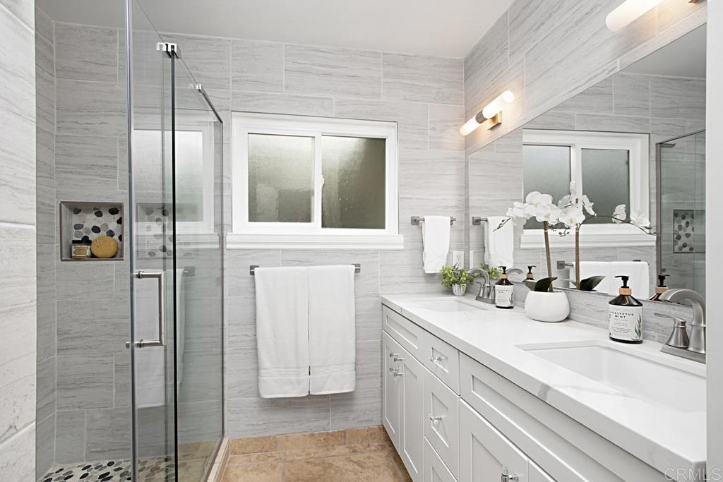1671 James Drive Carlsbad, CA 92008 - Photo 30 of 41 a bathroom with a sink and a mirror