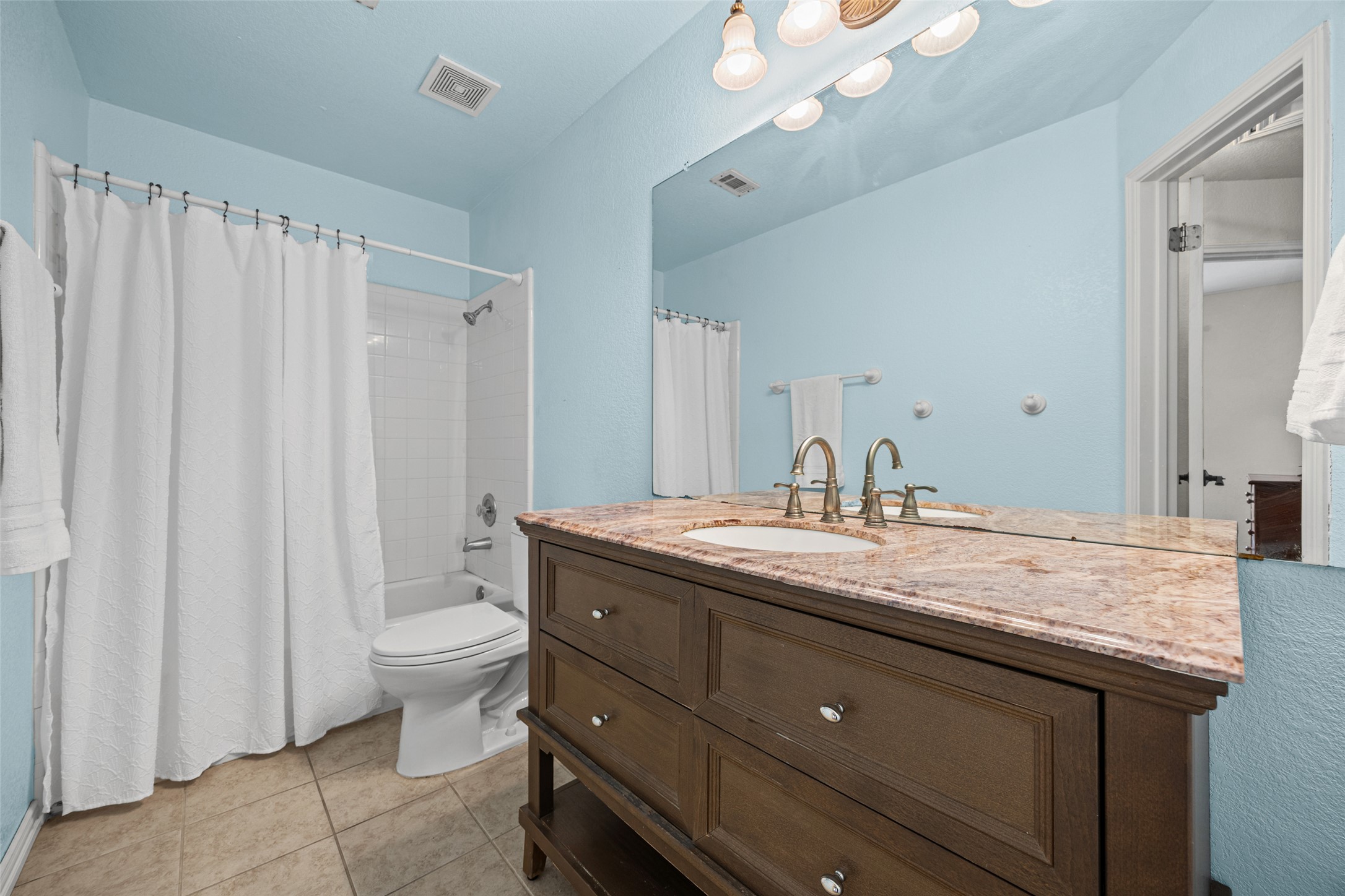 402 Autumn Trail Georgetown, TX 78626 - Photo 14 of 25 a bathroom with a granite countertop sink a toilet and a mirror