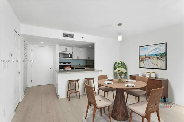 a view of a dining room with furniture and wooden floor