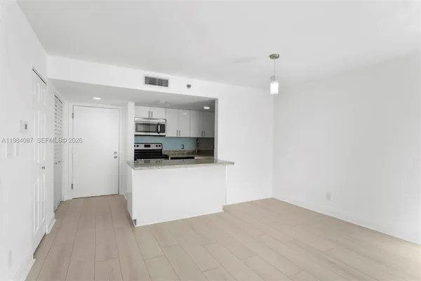a view of a kitchen with wooden floor