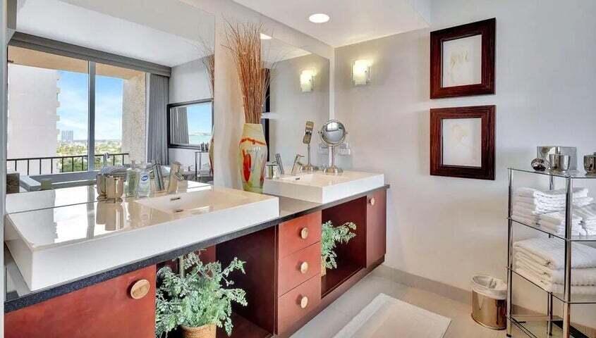 4200 North Ocean Drive, Unit 1905 Singer Island, FL 33404 - Photo 17 of 38 a bathroom with a double vanity sink and a mirror