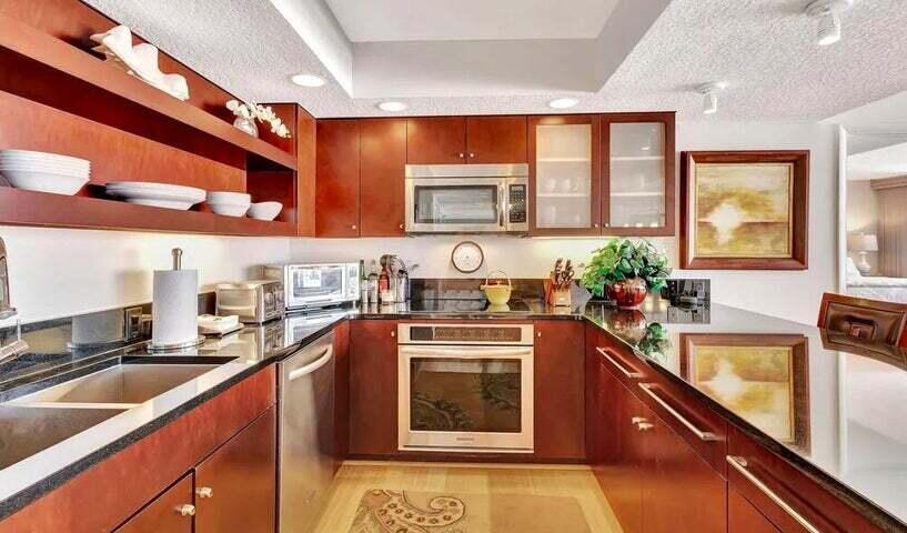4200 North Ocean Drive, Unit 1905 Singer Island, FL 33404 - Photo 18 of 38 a kitchen with stainless steel appliances a stove sink and cabinets