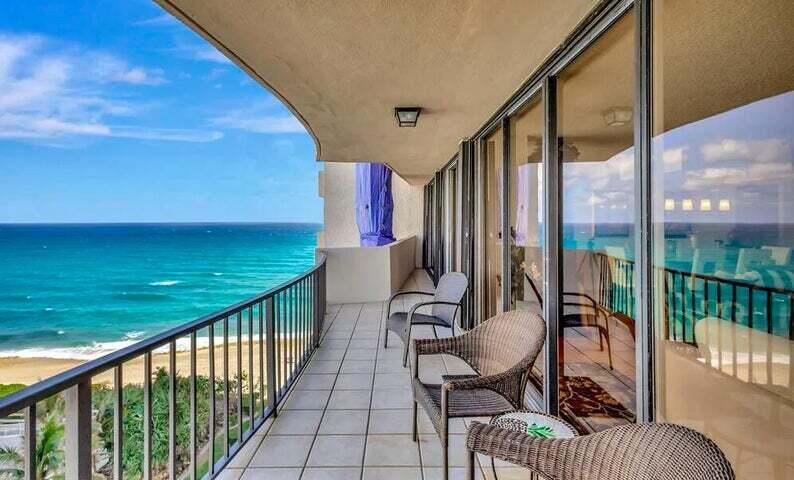 4200 North Ocean Drive, Unit 1905 Singer Island, FL 33404 - Photo 2 of 38 a view of a balcony with chairs and wooden fence
