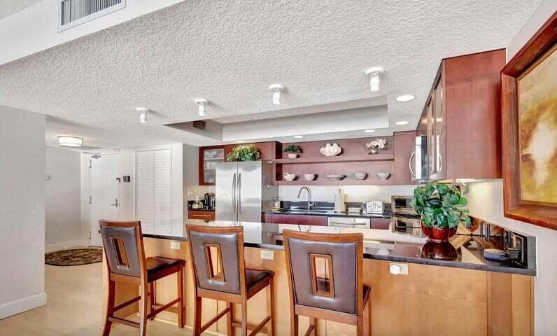 4200 North Ocean Drive, Unit 1905 Singer Island, FL 33404 - Photo 22 of 38 a dining room with furniture and a potted plant