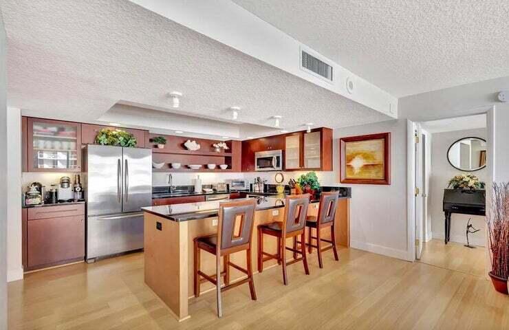 4200 North Ocean Drive, Unit 1905 Singer Island, FL 33404 - Photo 23 of 38 a kitchen with stainless steel appliances granite countertop a refrigerator and a stove top oven