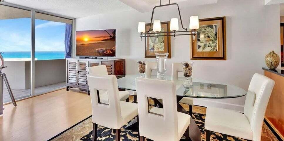 4200 North Ocean Drive, Unit 1905 Singer Island, FL 33404 - Photo 31 of 38 a kitchen with stainless steel appliances granite countertop a sink and a refrigerator