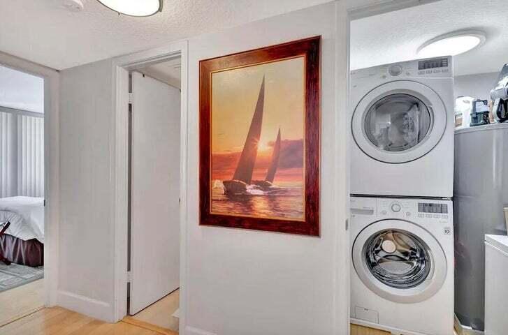 4200 North Ocean Drive, Unit 1905 Singer Island, FL 33404 - Photo 34 of 38 a view of a hallway with washer and dryer