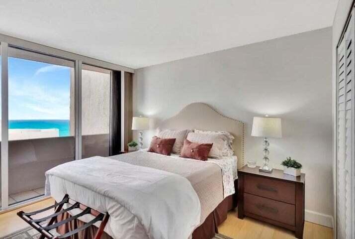 4200 North Ocean Drive, Unit 1905 Singer Island, FL 33404 - Photo 36 of 38 a bedroom with a bed and a large window